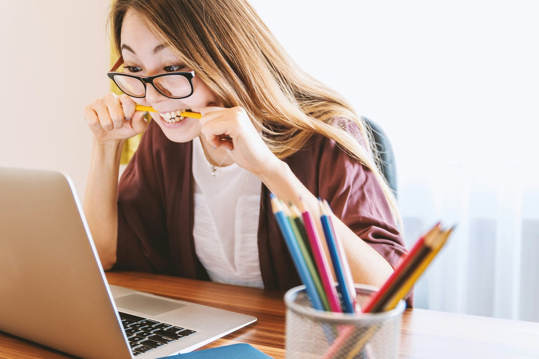 nervous lady biting pencil too much caffeine