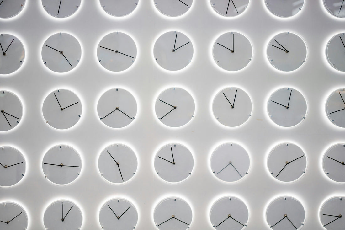 clocks on a wall showing different times