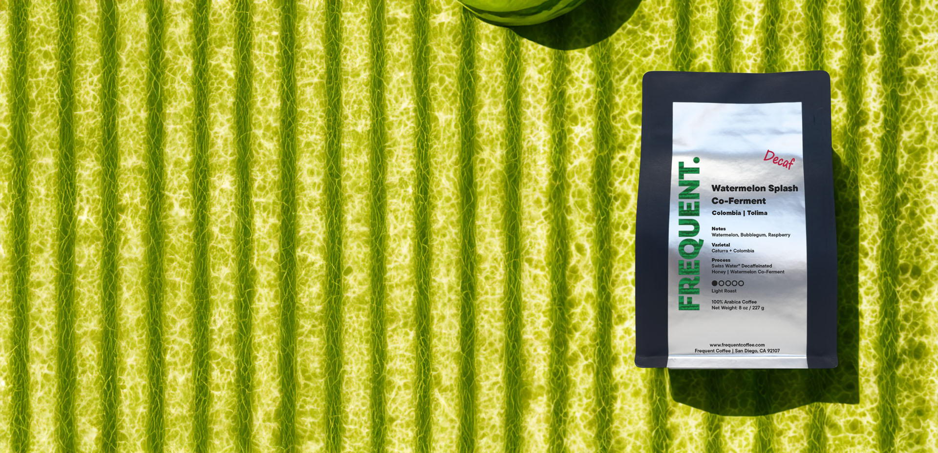 Watermelon Splash decaf on a textured green surface